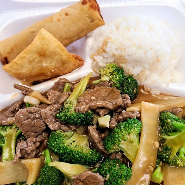 Tsing Tsao Chinese Fast Food's beef and broccoli with white rice, an egg roll, and a fried wonton.